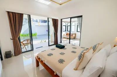 a bedroom with a bed in a room at Crystal Flow Guest House & Apartment Canggu in Canggu