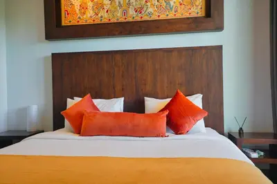 a bedroom with a bed with orange pillows at Luxury Villa 3br 5min to Seminyak beach in Seminyak