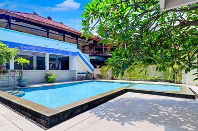 a swimming pool in front of a house at Townhouse Oak @lebak Bene Near Kuta Beach in Balian