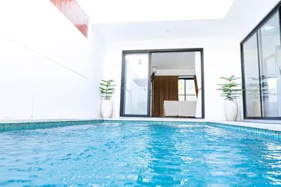 a swimming pool with blue water in a house at Brand New! Villa Putu Seminyak in Kerobokan