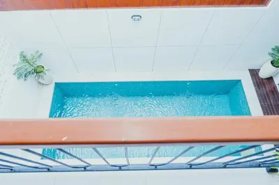 a pool of water in a room with a bench at Brand New! Villa Putu Seminyak in Kerobokan
