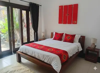 a bedroom with a large bed with red pillows at Villa Diraya 2 Bedroom Villa in Kerobokan in Kerobokan