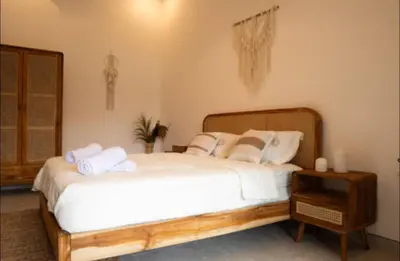 a bedroom with a large bed with towels on it at GB UNLU Villas in Kerobokan