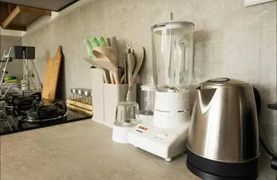 a kitchen counter with a blender and utensils at GB UNLU Villas in Kerobokan