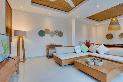 a living room with a couch and a table at Family 3BR Villa Laviosa in Petitenget near Beach in Seminyak