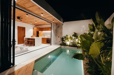 an indoor pool in a house with plants at La Payesa 2 in Canggu