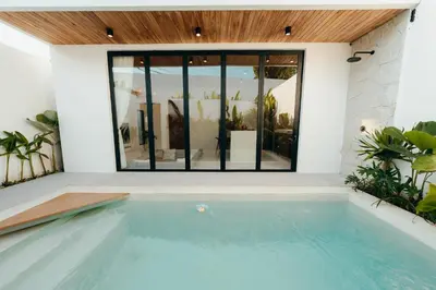 a swimming pool in the middle of a house at La Payesa 2 in Canggu