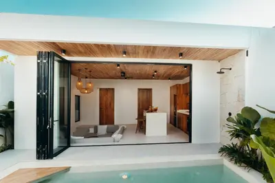 a room with a pool in a house at La Payesa 2 in Canggu