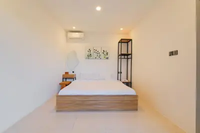 a bedroom with a bed in a room at 4BR Modern Villa walking dist to Sidewalk Jimbaran in Jimbaran