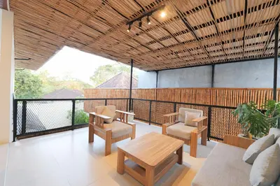 a living room with a table and chairs on a balcony at 4BR Modern Villa walking dist to Sidewalk Jimbaran in Jimbaran