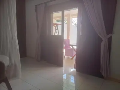 an open door to a dining room with a table at Villa Private In Kuta Bali in Kuta