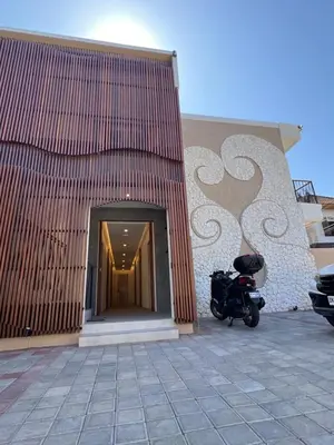 a motorcycle parked in front of a building at Luminera Bali Apartment in Nusa Dua