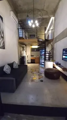 a living room with a couch and a table at Arzella Apartment in Seminyak