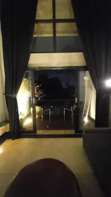 a view of a living room with a large window at Arzella Apartment in Seminyak