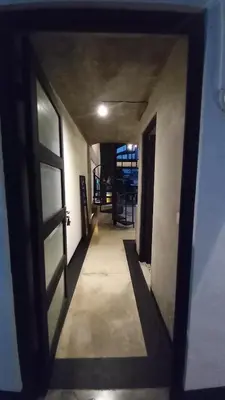 a hallway with a door leading to a room at Arzella Apartment in Seminyak