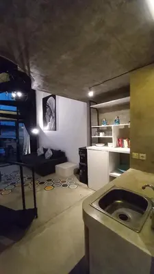 a living room with a sink in a room at Arzella Apartment in Seminyak