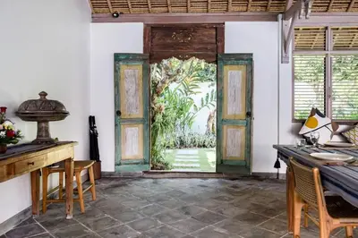 an open door in a room with a table and chairs at Five Star Reviews, Airbnb Plus, Awesome Location in Seminyak