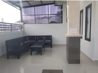 a room with two black benches and a window at Omah Chandra in Pesanggaran