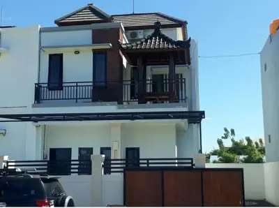 a large white house with a balcony on top of it at Omah Chandra in Pesanggaran