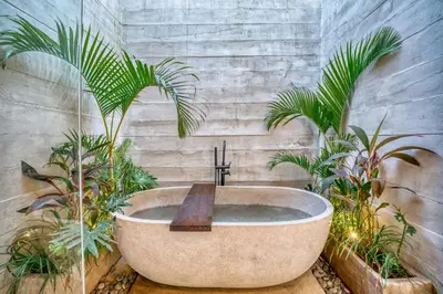 a bathroom with a bath tub with plants at New! Architectural 2BR Villa near Seminyak in Kerobokan