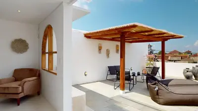 a living room with a patio with a table and chairs at Minimalist & Bohemian 2Br Villa in Seminyak in Seminyak