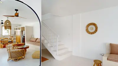 a living room and staircase in a house at Minimalist & Bohemian 2Br Villa in Seminyak in Seminyak