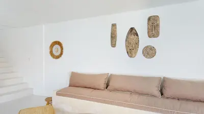a living room with a couch on a white wall at Minimalist & Bohemian 2Br Villa in Seminyak in Seminyak