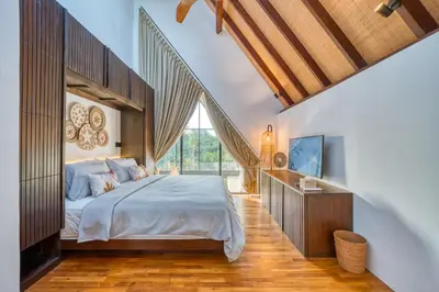 a bedroom with a bed and a large window at New! Designer Arch Villa with pool near Seminyak in Kerobokan