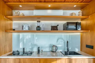 a kitchen with a sink and a stove at New! Designer Arch Villa with pool near Seminyak in Kerobokan