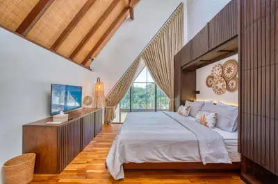 a bedroom with a large bed and a large window at New! Designer Arch Villa with pool near Seminyak in Kerobokan