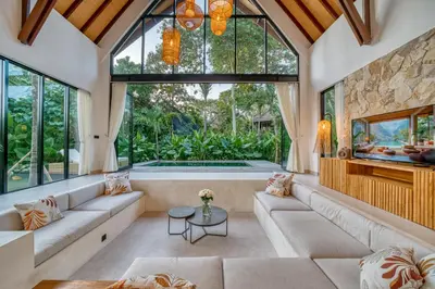 a living room with a large window and a tub at New Tranquil Jungle View Villa in Kerobokan in Kerobokan