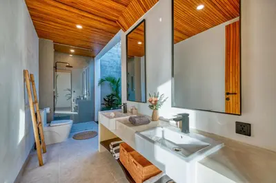 a bathroom with two sinks and a mirror at New Tranquil Jungle View Villa in Kerobokan in Kerobokan