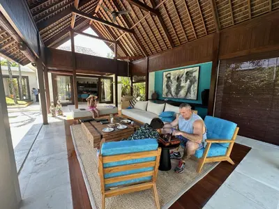 a man and a boy sitting at a table in a living room at Saba Villas in Canggu