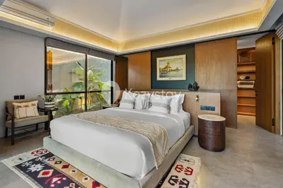 a bedroom with a large white bed in a room at Andra Villa by Kozystay - Natadesa Resort Jimbaran in Jimbaran