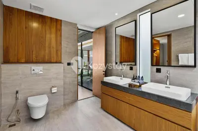 a bathroom with two sinks and a toilet at Andra Villa by Kozystay - Natadesa Resort Jimbaran in Jimbaran