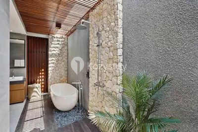 a bathroom with a bath tub and a sink at Andra Villa by Kozystay - Natadesa Resort Jimbaran in Jimbaran