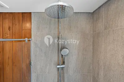 a shower with a glass door in a bathroom at Andra Villa by Kozystay - Natadesa Resort Jimbaran in Jimbaran