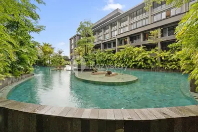 a large swimming pool in front of a building at Caraya by Kozystay - Nusa Dua in Nusa Dua