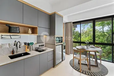 a kitchen with a table and a dining room at Levora by Kozystay - Nusa Dua in Nusa Dua