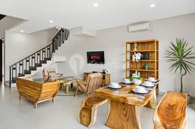 a living room with a wooden table and chairs at Manisha Villa by Kozystay - Seminyak in Seminyak