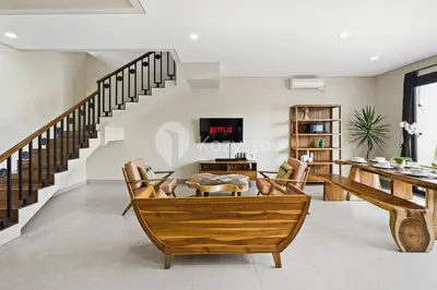 a living room with a wooden table and chairs at Manisha Villa by Kozystay - Seminyak in Seminyak