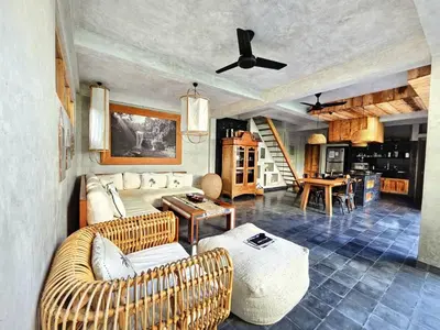 a living room with a couch and a table at Villa Hibou - New Tropical Luxury 2BR near Canggu in Canggu