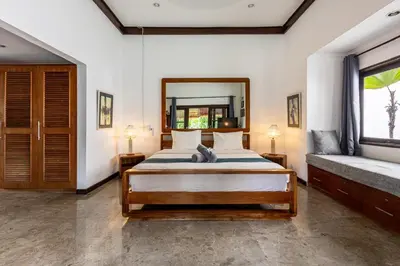 a bedroom with a bed and a large mirror at Seminyak Most Wanted Villa for family vacation in Seminyak