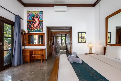 a bedroom with a bed and a desk in it at Seminyak Most Wanted Villa for family vacation in Seminyak