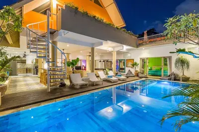 a villa with a swimming pool and a house at Villa Josefine, 5 Bedroom pool, rooftop, pool table in Seminyak
