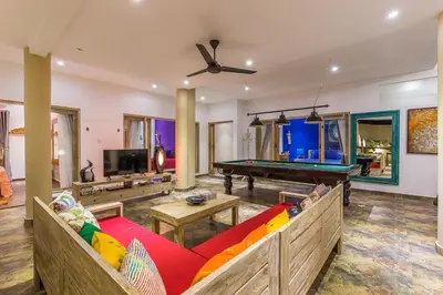 a living room with a pool table and a couch at Villa Josefine, 5 Bedroom pool, rooftop, pool table in Seminyak