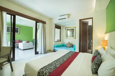 a hotel room with a bed and a couch at Royal Samaja Villas in Seminyak