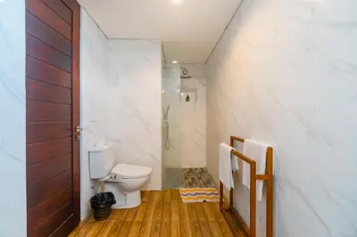 a bathroom with a toilet and a walk in shower at Villa C31 Seminyak in Seminyak