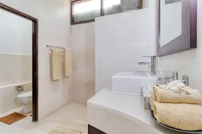 a white bathroom with a sink and a toilet at 3BR Seminyak Oasis, Sleeps 6, Walk to RestBars in Seminyak
