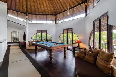 a pool table in a room with windows at 3BR Seminyak Oasis, Sleeps 6, Walk to RestBars in Seminyak